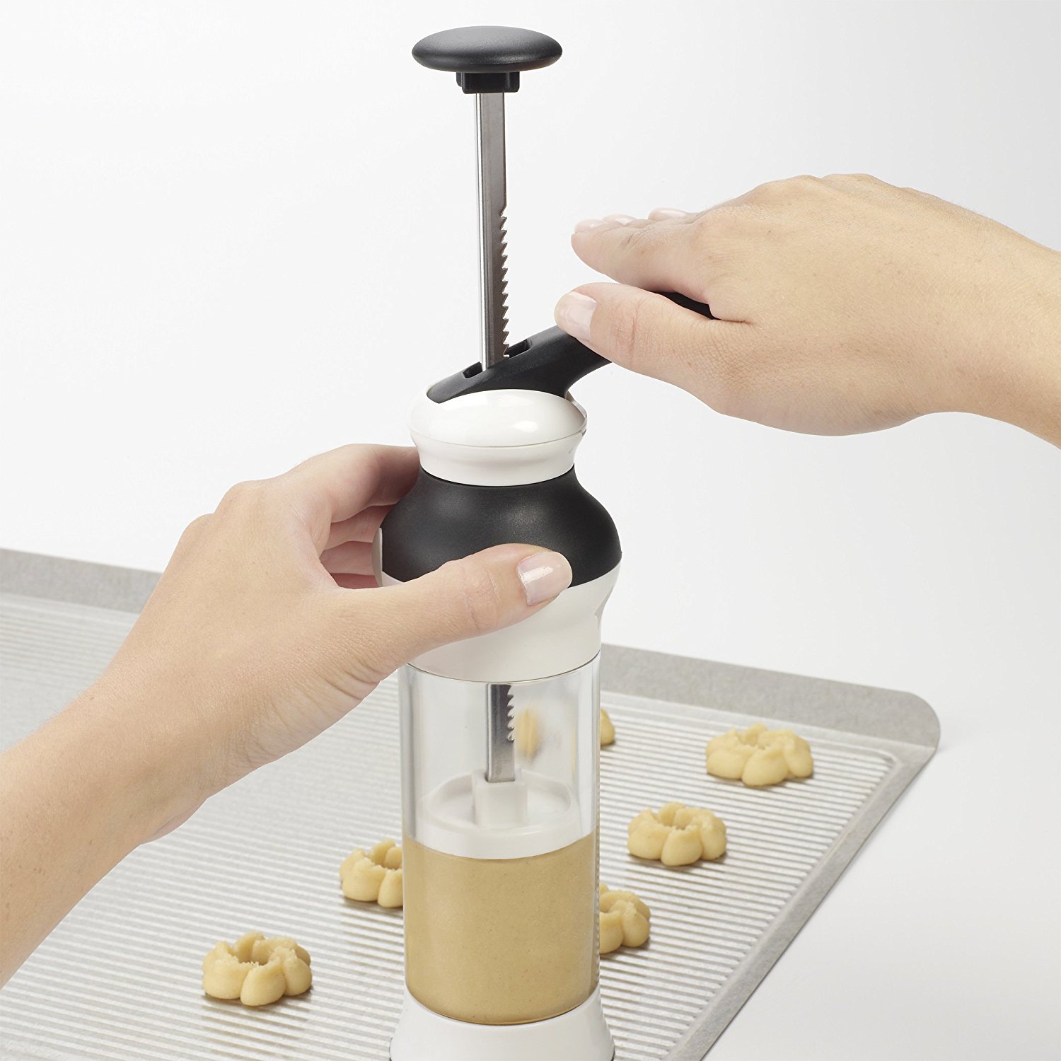 Use a cookie press to make decorative cookies with The Cookie Elf.